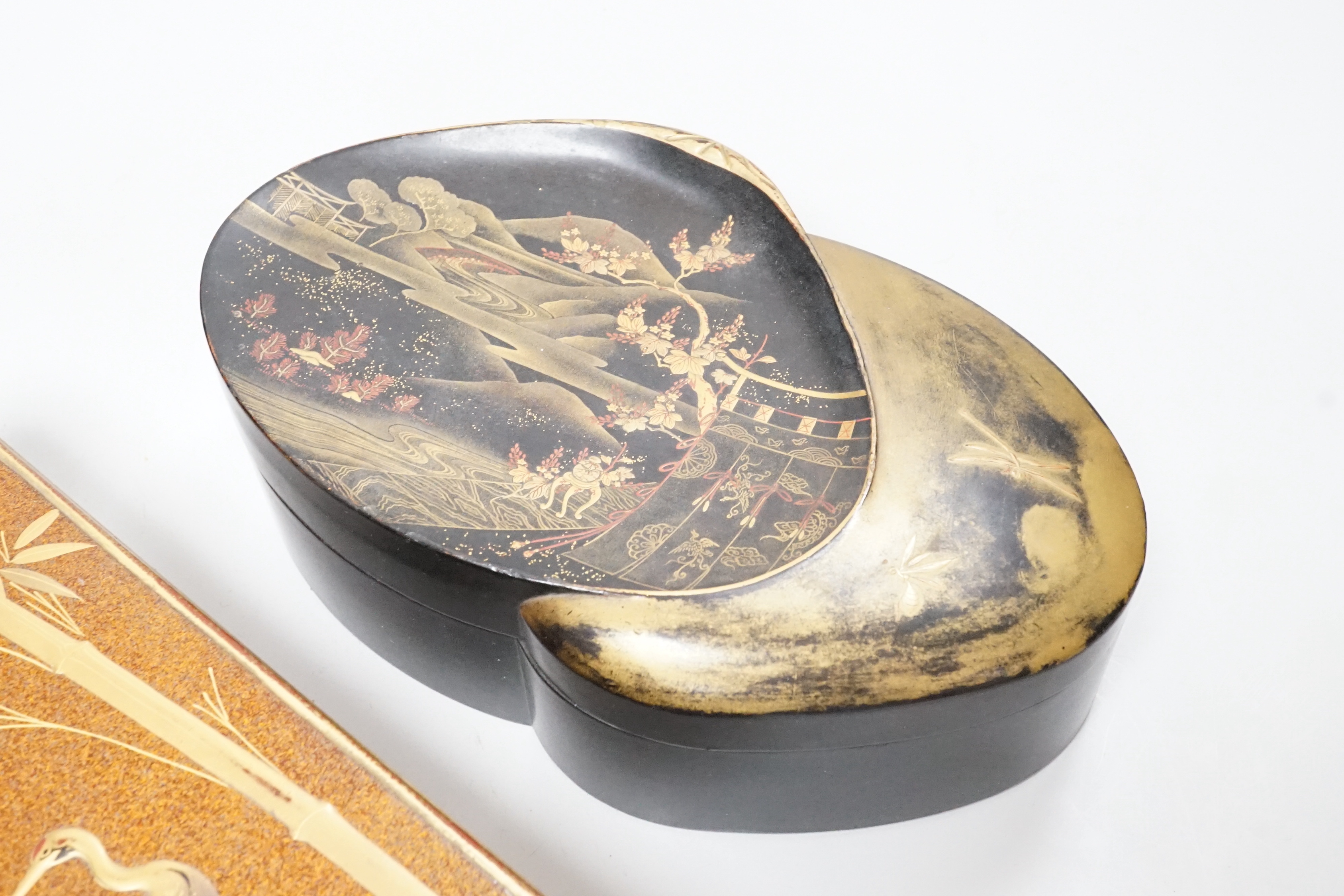 A Japanese lacquer rectangular box and cover, signed, Taisho period and a Japanese clam-shell shaped lacquer box and cover, Meiji period, largest 26cm wide (2)